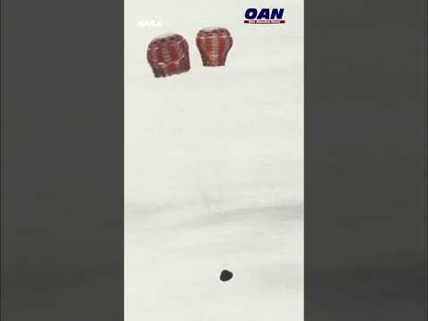 NASA: Orion's main parachute has deployed as the Artemis II crew splashes down to earth.