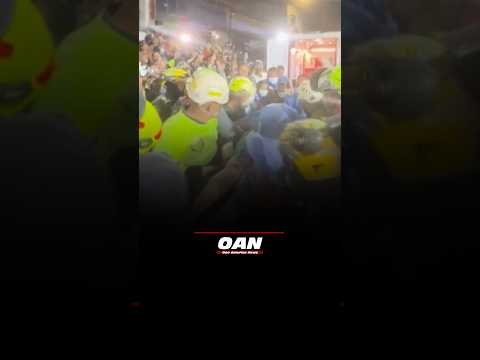 Colombian firefighters pull survivor from the remains of a destroyed building